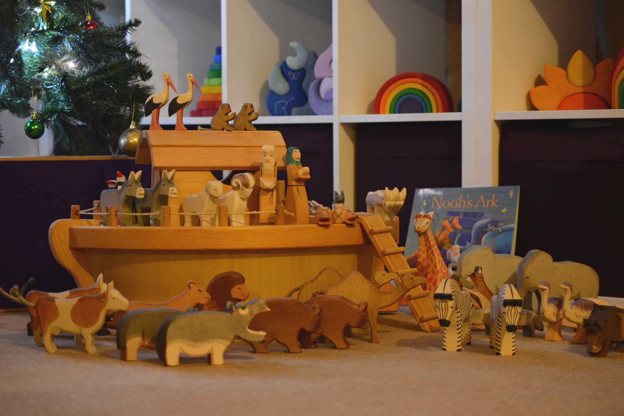 The Ostheimer ark set up with the ship's cabin and lots of wooden animal figures on and around the ark. 