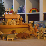 The Ostheimer ark set up with the ship's cabin and lots of wooden animal figures on and around the ark. 