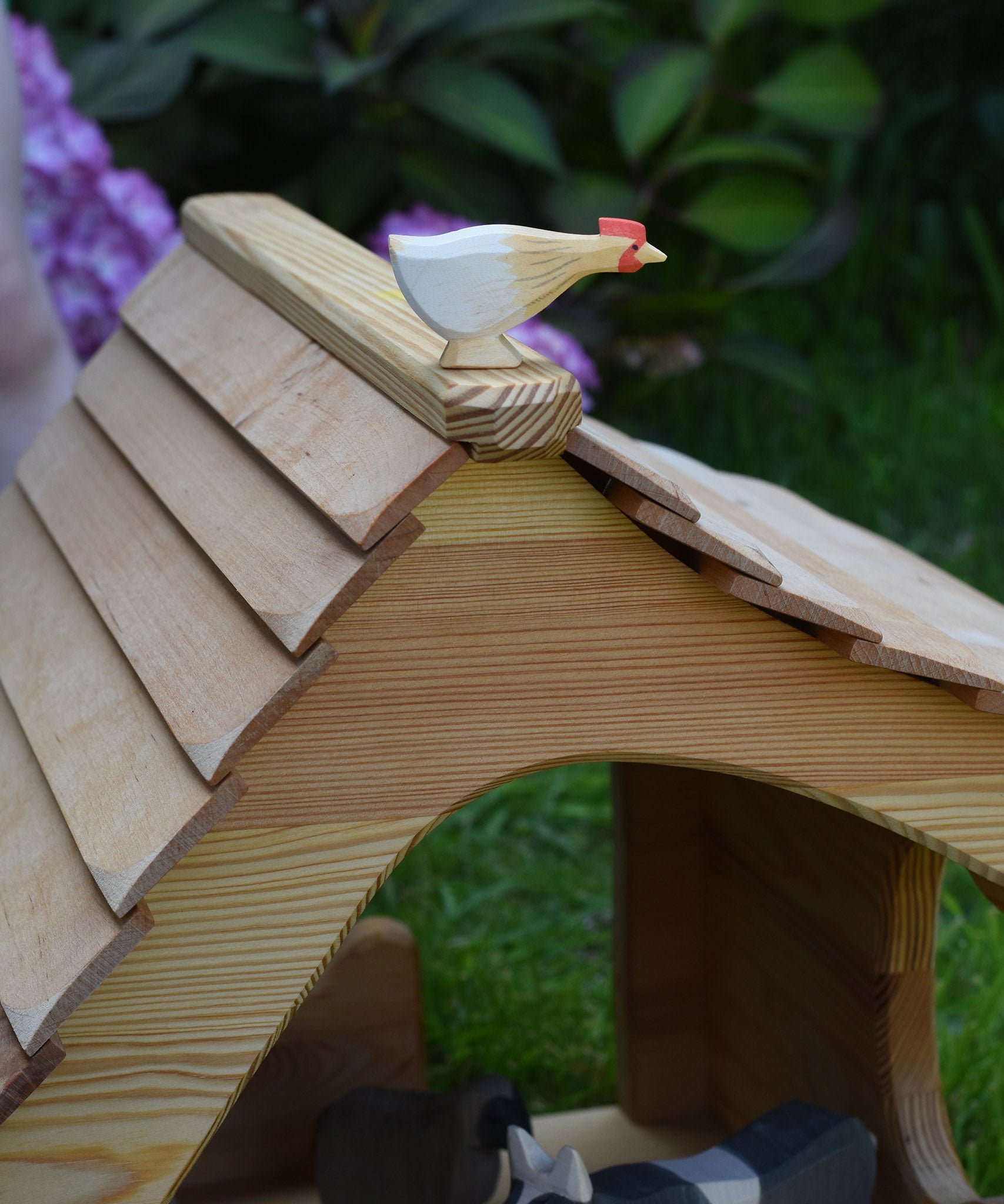 An Ostheimer hen with long neck standing on the roof of an Ostheimer cottage. These wooden figures are part of a large range of expertly hand crafted, Waldorf inspired, wooden toys here at Babipur. 
