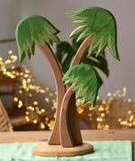 Ostheimer palm tree group with support base placed on green cotton play cloths.