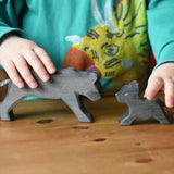 Child playing with the Ostheimer black panther handmade wooden toy figures.