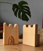 Ostheimer wooden castle parapets pieces placed on a wooden surface.
