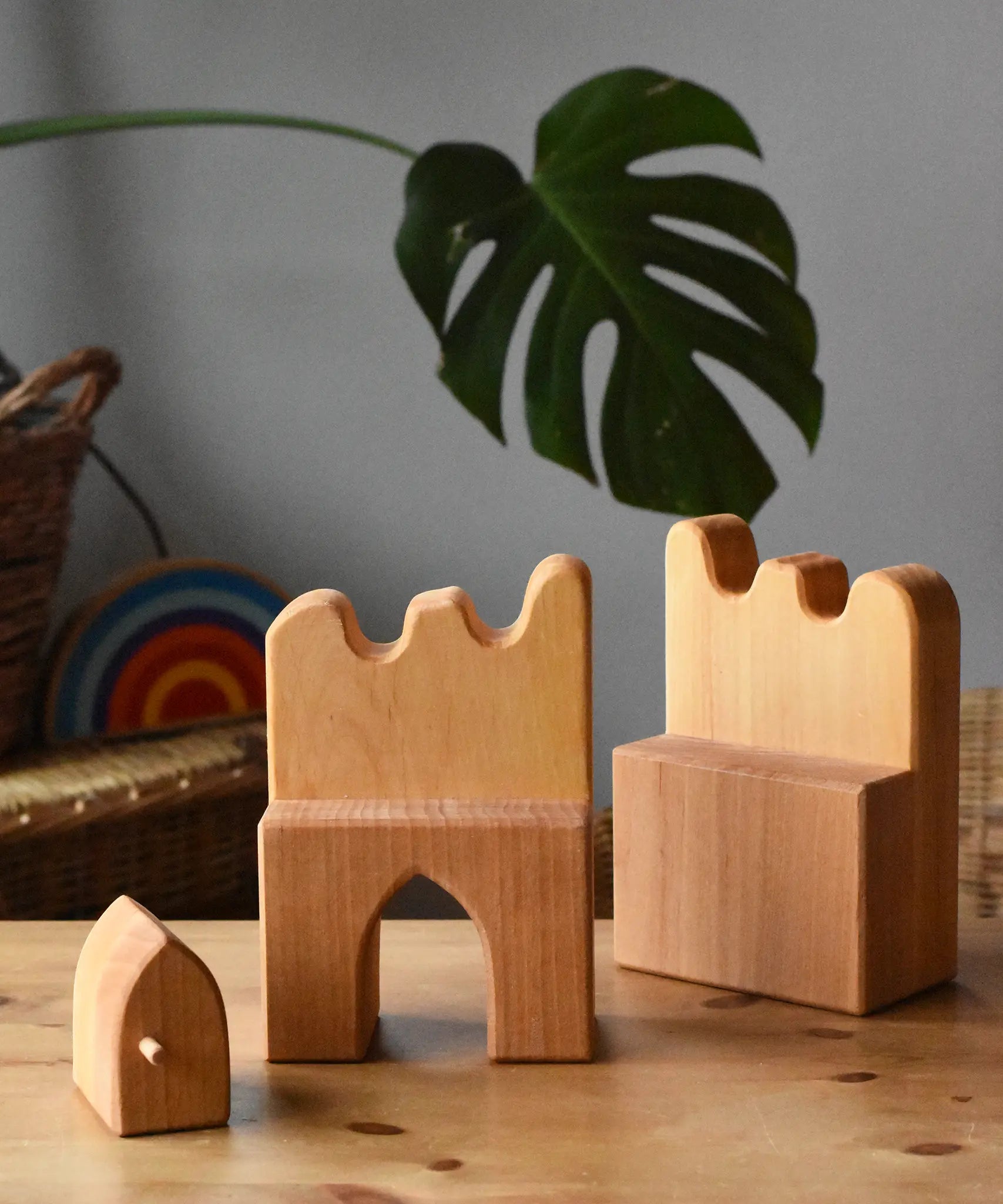 Ostheimer wooden castle parapets pieces with door taken out placed on a wooden surface.