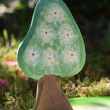 Ostheimer wooden golden pear tree shown on the blue flower blossom side on a pond scenery piece.
