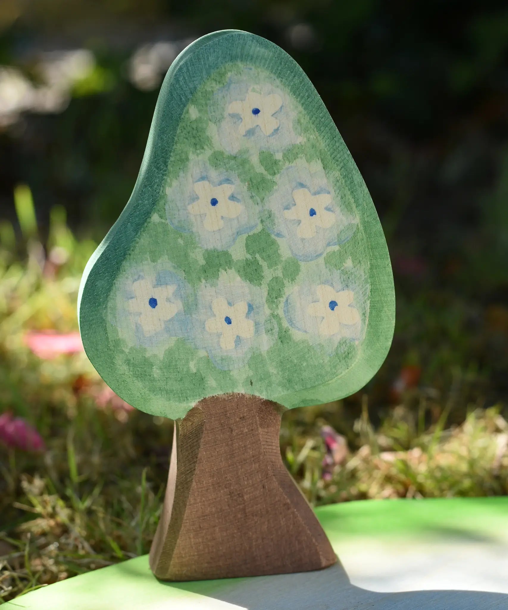 Ostheimer wooden golden pear tree shown on the blue flower blossom side on a pond scenery piece.