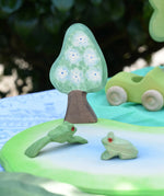 Ostheimer wooden golden pear tree shown on the blue flower side scenery piece used in a small world play set up with a pond piece and frogs. 