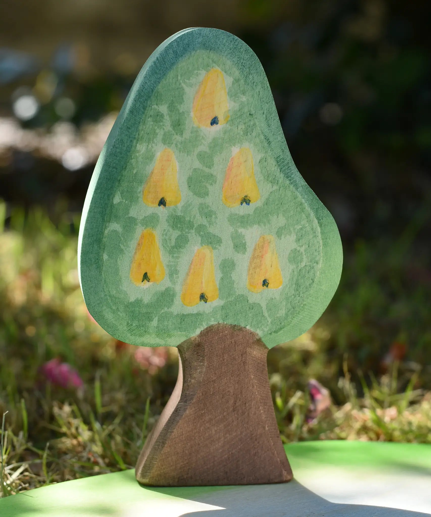 Ostheimer wooden golden pear tree shown on the golden pear fruit side on a pond scenery piece.