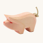Ostheimer piglet wooden toy figure on a plain background. 