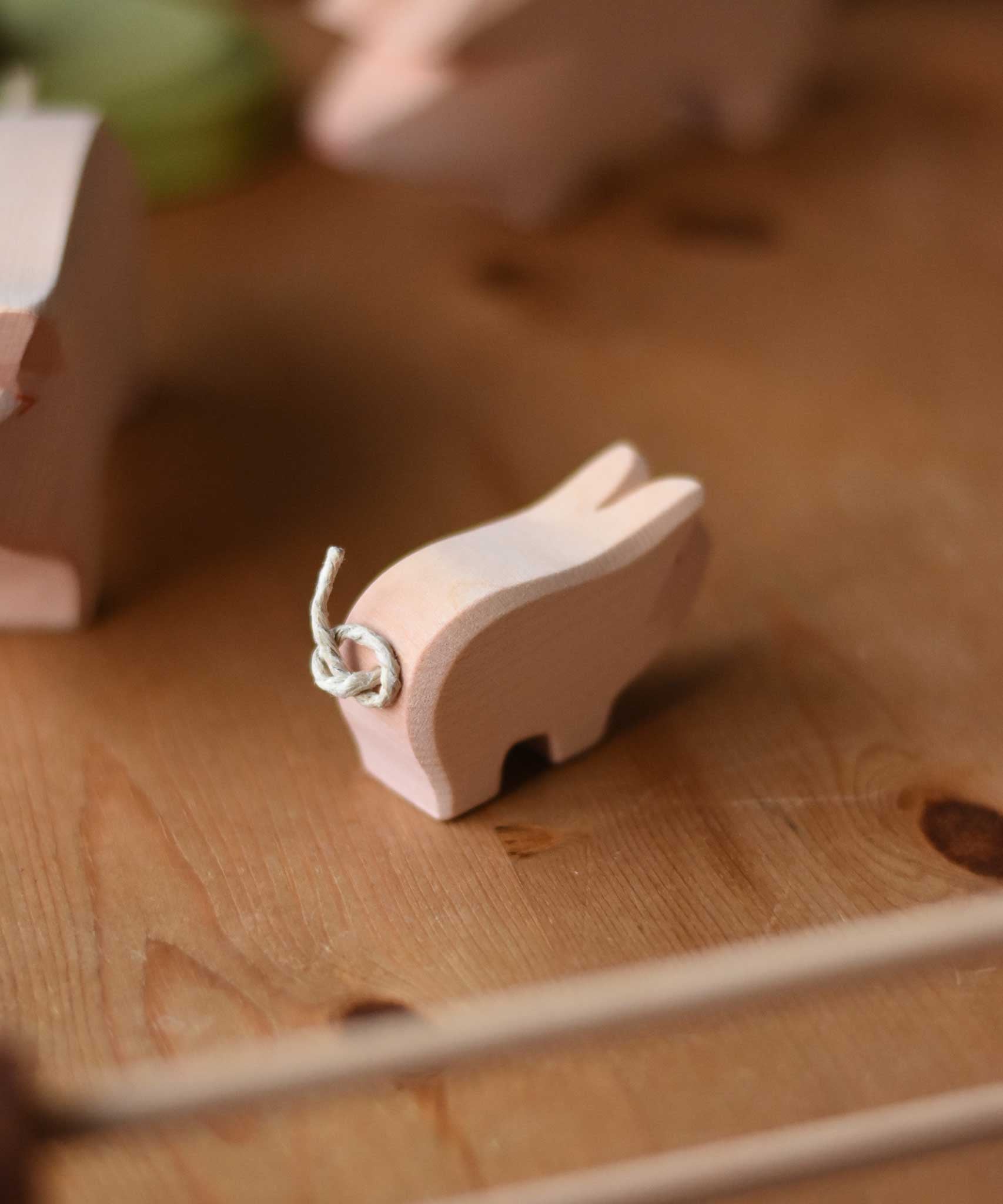 A close up of the tail on the Ostheimer wooden toy pink piglet figure. These wooden figures are part of a wide range of expertly hand crafted wooden toys here at Babipur. 