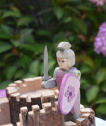 An Ostheimer pink knight placed on the turret of a Magic Wood castle. This wooden figure is part of a large range of expertly hand crafted wooden toys here at Babipur. 