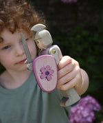 A child holding an Ostheimer pink standing knight in his hand. This wooden figure is part of a large range of expertly hand crafted wooden toys here at Babipur. 