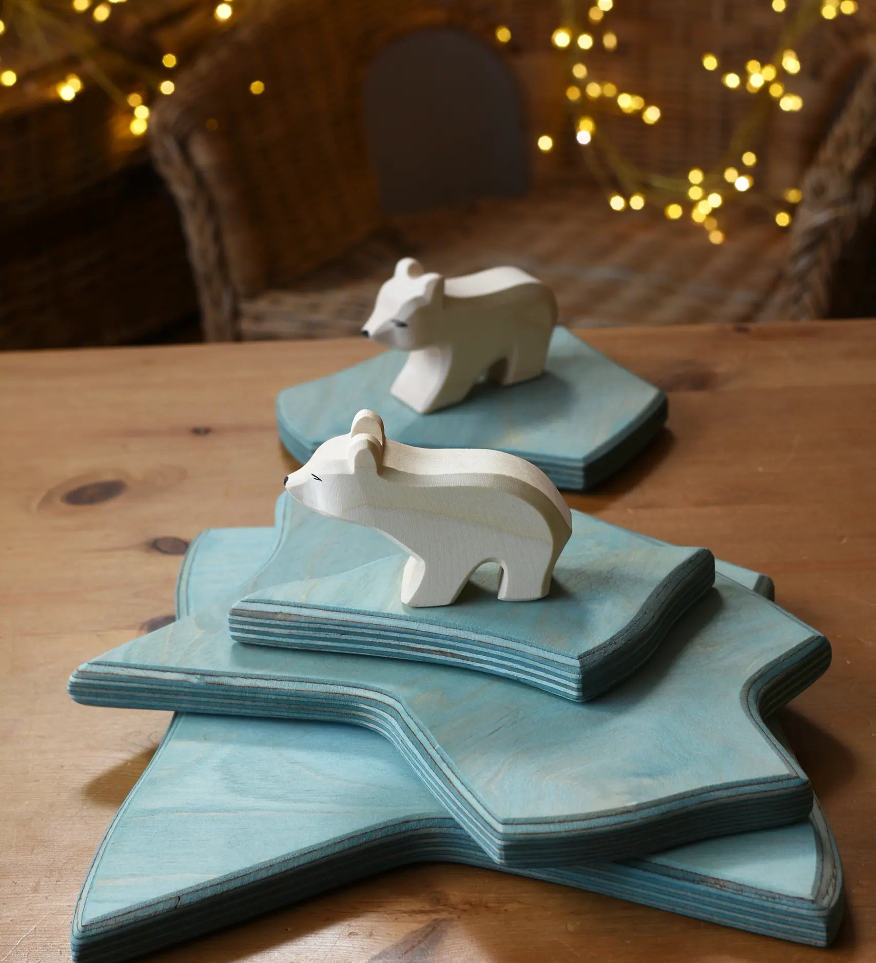 Ostheimer polar bear wooden toy figure with a long neck placed on a stack of ice floe scenery pieces. 