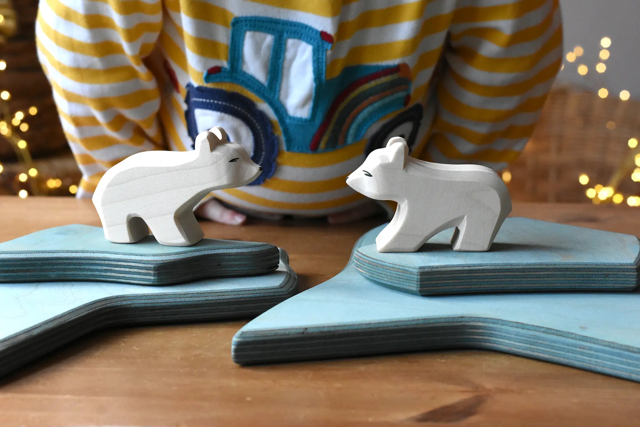 Ostheimer polar bear wooden toy figures placed on a stack of ice floe scenery pieces. 