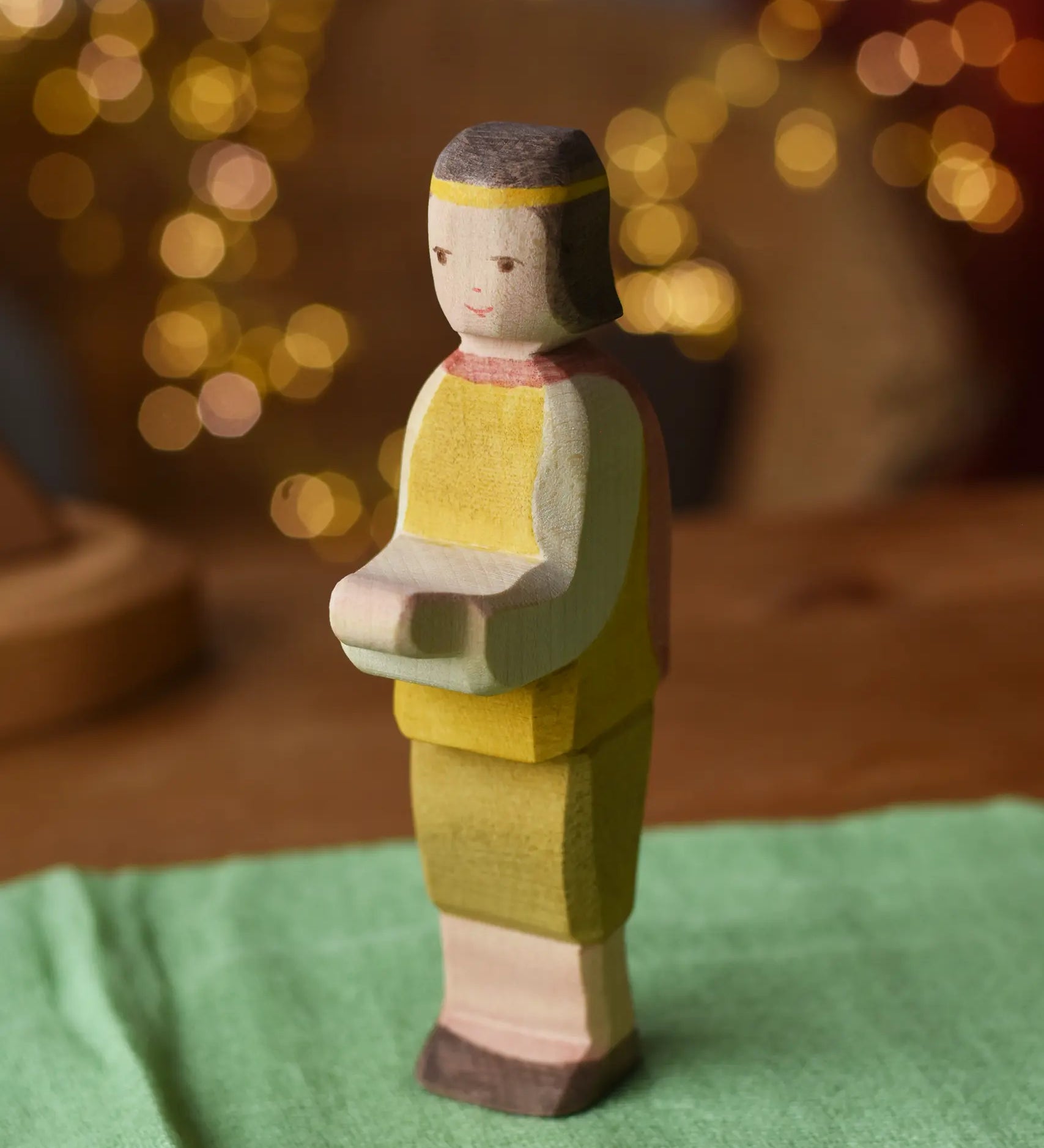 Ostheimer prince wooden toy figure placed on a green cotton play cloth. 