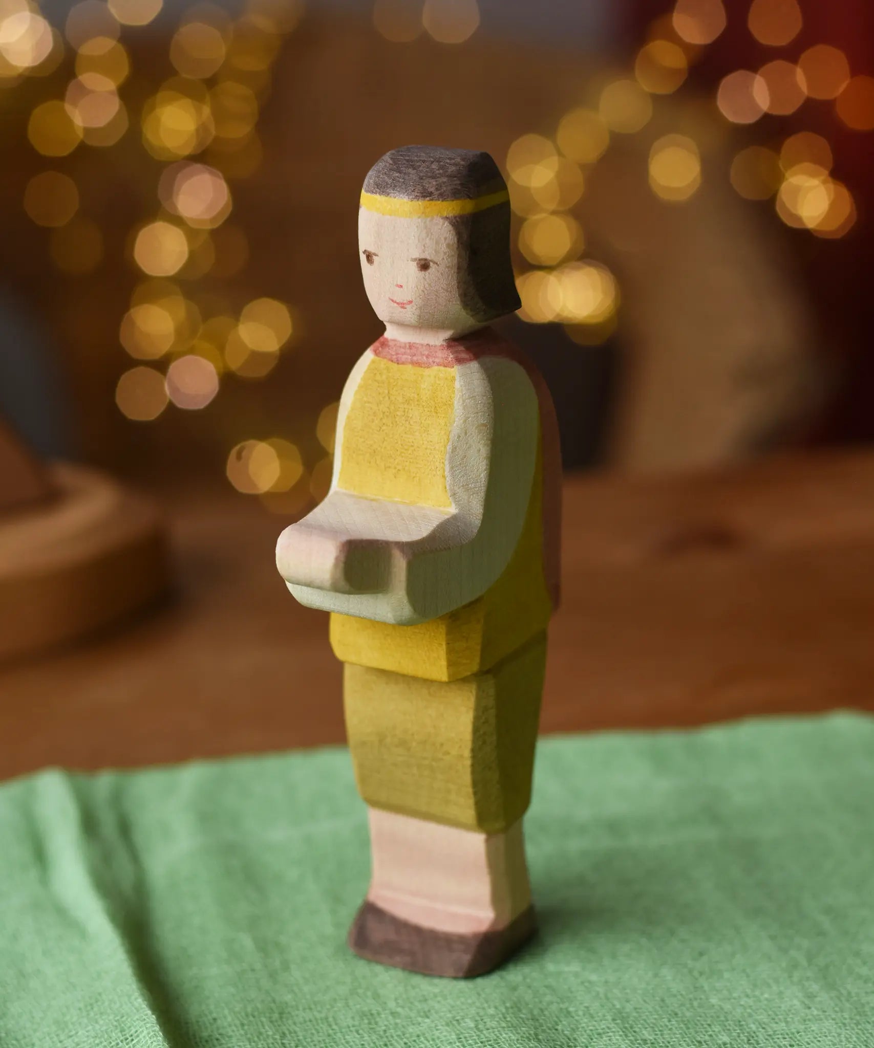 Ostheimer prince wooden toy figure placed on a green cotton play cloth. 