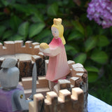 An Ostheimer pink princess for frog prince placed on the turret of a Magic Wood castle. This wooden figure is part of a large range of expertly hand crafted, Waldorf inspired, wooden toys here at Babipur. 