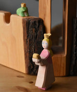 Ostheimer princess for frog king on a wooden surface in front of the tower and castle walls with the frog king in the background.