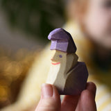 Ostheimer amethyst dwarf wooden toy figure in an adult's hand.