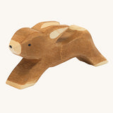 Ostheimer wooden toy running rabbit figure on a cream background. 