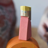 Red king wooden figures from the Ostheimer Rainbow Castle Block set placed on orange arch piece. 