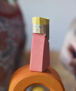 Red king wooden figures from the Ostheimer Rainbow Castle Block set placed on orange arch piece. 