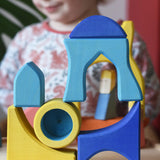 Yellow and blue Ostheimer Rainbow Castle Blocks stacked and balanced on each other.