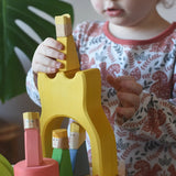 Yellow king wooden figure placed on the yellow castle piece from the Ostheimer Rainbow Castle Block set.