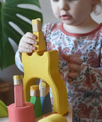 Yellow king wooden figure placed on the yellow castle piece from the Ostheimer Rainbow Castle Block set.