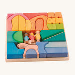 Ostheimer Rainbow Rider Farm wooden toy blocks set on a plain background. The blocks are placed in the wooden tray that they come with. 
