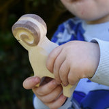 Ostheimer white ram wooden toy figure in a child's hand.