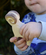 Ostheimer white ram wooden toy figure in a child's hand.
