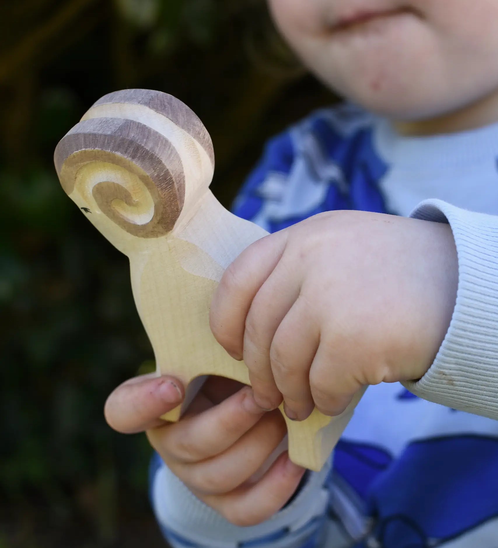 Ostheimer white ram wooden toy figure in a child's hand.