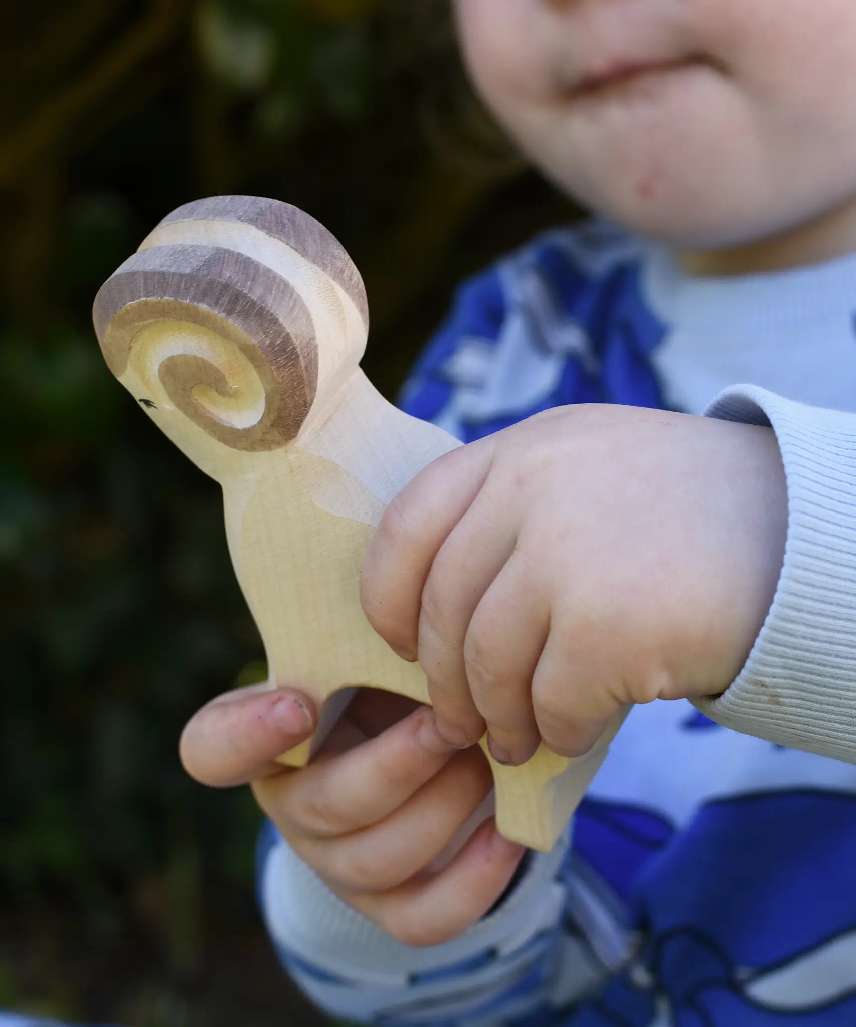 Ostheimer white ram wooden toy figure in a child's hand.