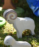 Ostheimer white ram wooden toy figure placed on grass in the Babipur garden. 