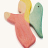 A red wooden angel figure on a cream background