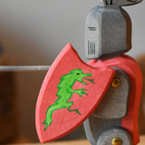 Close up of the Ostheimer black riding knight handmade wooden toy figure with shield and long sword.