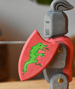 Close up of the Ostheimer black riding knight handmade wooden toy figure with shield and long sword.