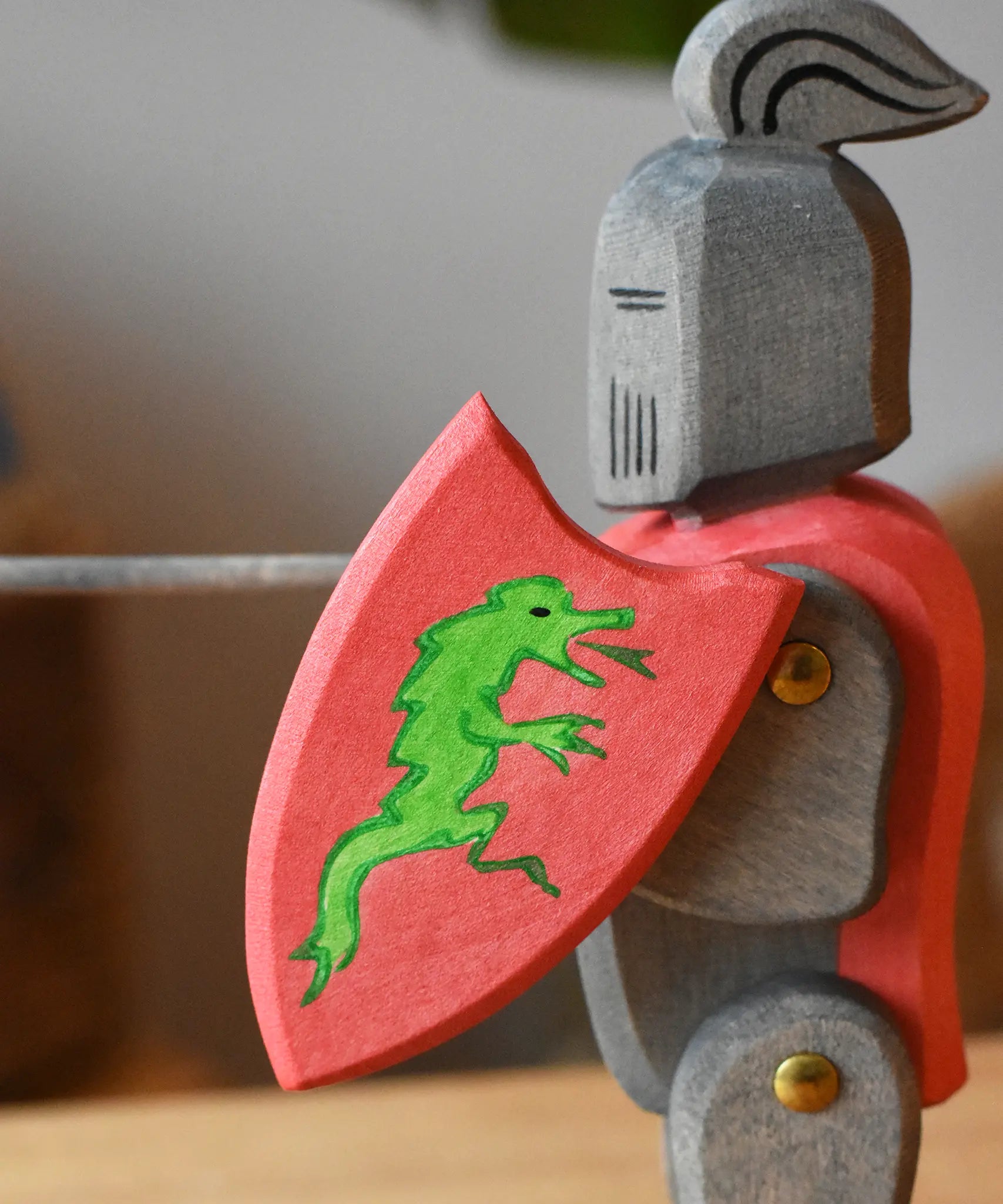 Close up of the Ostheimer black riding knight handmade wooden toy figure with shield and long sword.