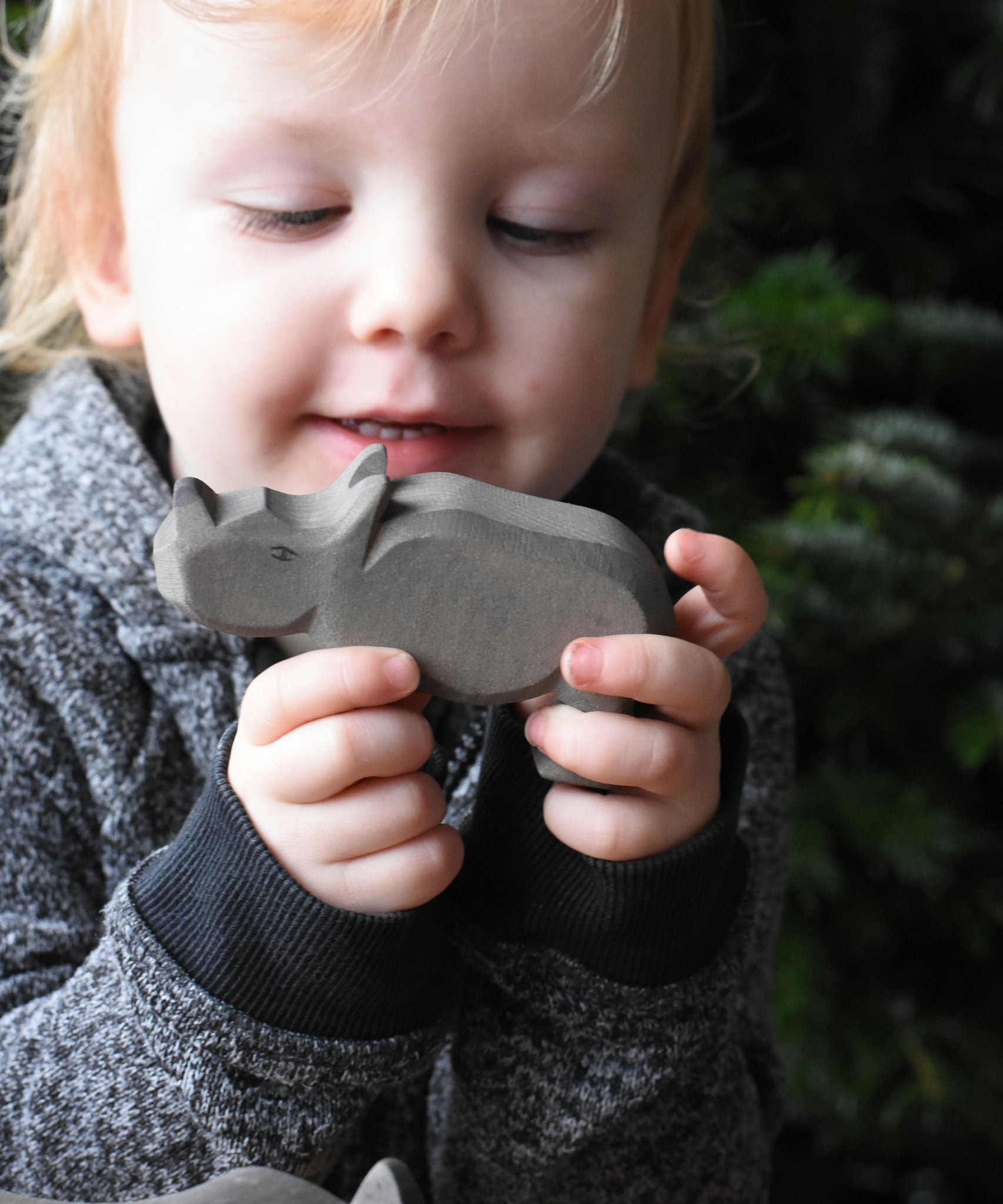 A child holding the small Ostheimer wooden toy figure. These wooden figures are part of a wide range of expertly hand crafted wooden toys here at Babipur.