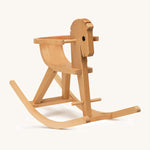 A wooden rocking horse with arm rests on a cream background