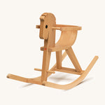 A different angle of the wooden rocking horse on a cream background