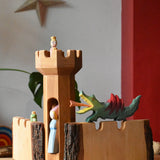 Ostheimer large wooden castle walls with a round tower in the middle. A dragon resting on one wall, frog king on the other and princesses in the tower.