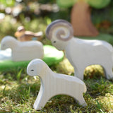 Ostheimer running lamb wooden toy figure placed on grass in the Babipur garden. 