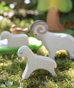 Ostheimer running lamb wooden toy figure placed on grass in the Babipur garden. 