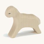 A white wooden Ostheimer running lamb figure on a cream background.