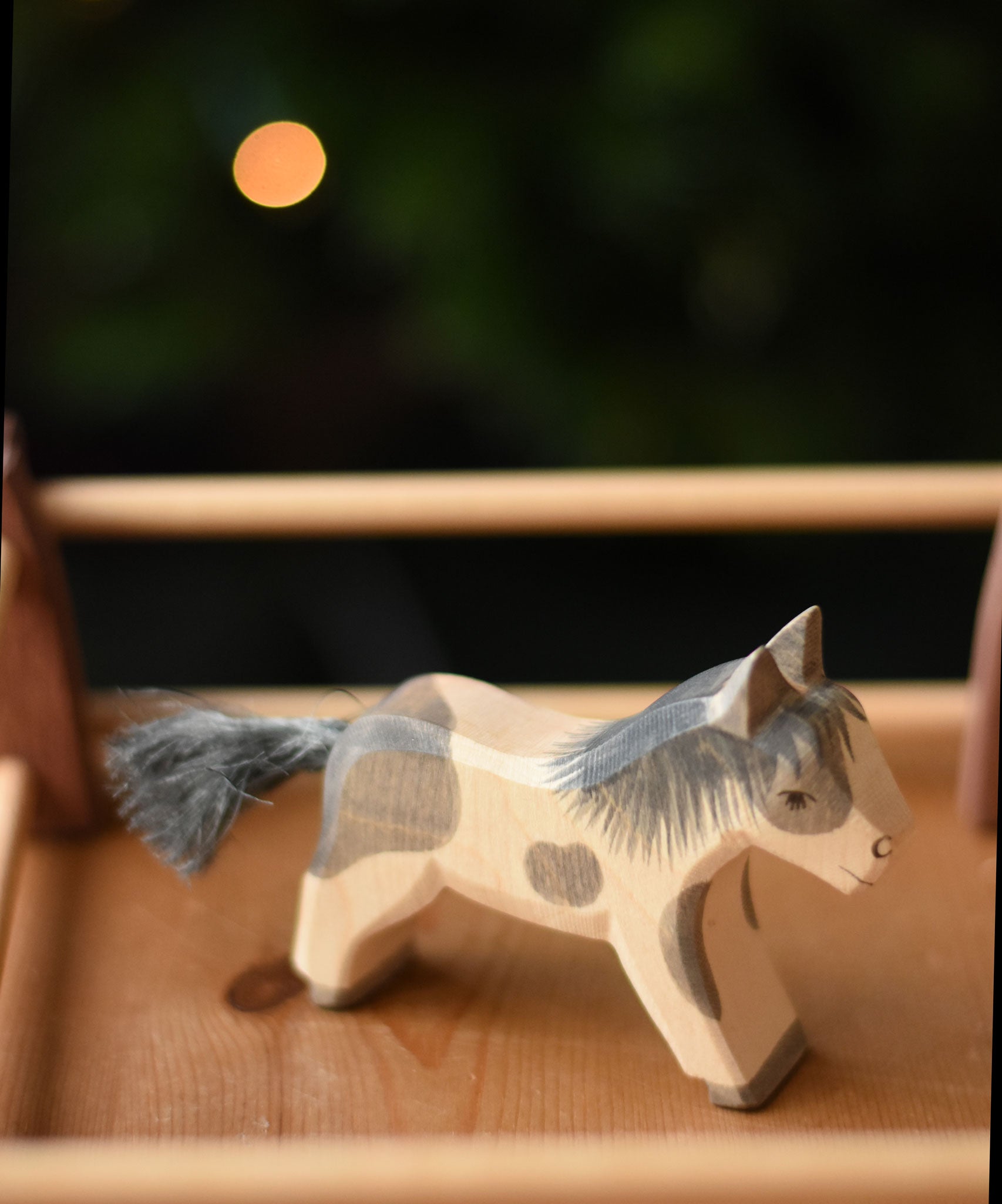 An Ostheimer shetland pony wooden toy figure placed in a pen created with Ostheimer wooden fence pieces.  Ostheimer's range of hand crafted, heirloom quality wooden toys are available to buy at Babipur. 