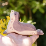 Ostheimer sea lion head high wooden toy figure in an adult's hand. 