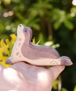 Ostheimer sea lion head high wooden toy figure in an adult's hand. 