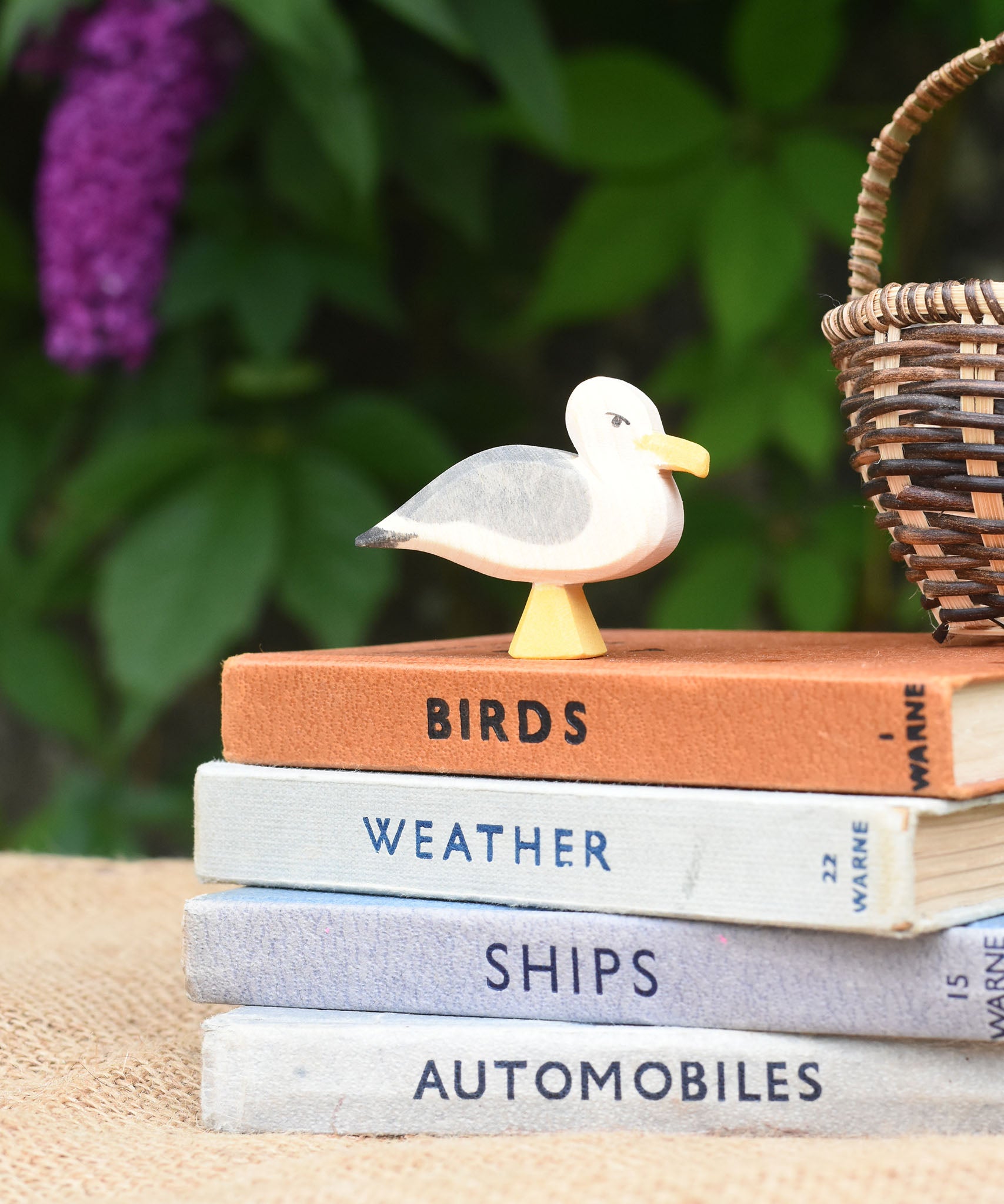 An Ostheimer seagull placed on a pile of books.