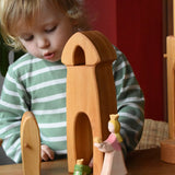 Child playing with the Ostheimer castle sentry post building with bell with the princess and frog king in front.